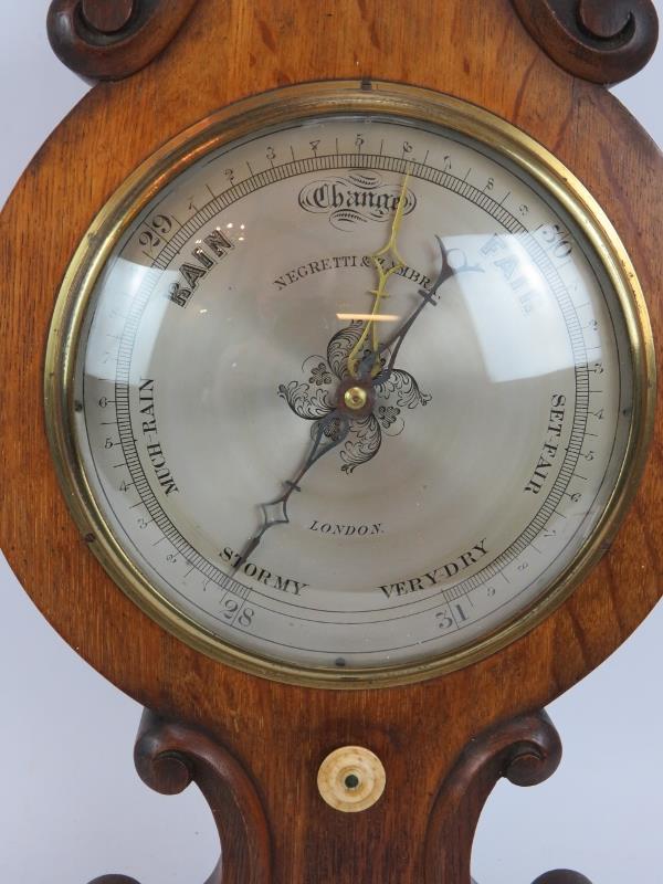 A Victorian Negretti and Zambra wheel barometer in oak veneer case with silvered dial. Overall - Image 2 of 6