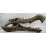 A large composite model of a prehistoric alligator skull, with hinged jaw and prop stand.