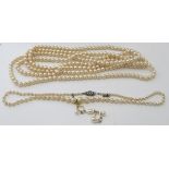 An exceptionally long strand of simulated pearls, 70" long, a graduated Lotus pearl necklace with