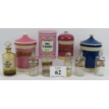 A collection of ten apothecary jar and bottles including four covered ceramic jars. Most with