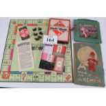 A WW2 era monopoly board game, seemingly unused, a Dean's alphabet rag book and a Little Tots record