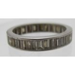 An unmarked white metal diamond eternity ring set with 34 baguette cut diamonds, size M. Condition