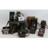 A collection of vintage camera equipment including a Yashica-mat TLR camera, three Bellows cameras