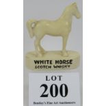 A vintage White Horse Scotch whisky advertising figure, no maker's marks. Height 14cm. Condition