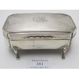 An Art Deco silver rectangular trinket box on pad feet. Engine turned decoration with centre