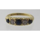 An 18ct yellow gold ring set with three sapphires and two diamonds, size N, approx weight 4.5 grams.