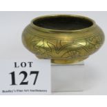 A Chinese brass censer of squat form with engraved design to body and six character mark to base.
