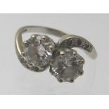 A vintage 18ct white gold two diamond cross over ring with diamond shoulders, approx 2cts, size O,