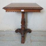 A William IV rosewood occasional table with gadrooned edging, over a baluster turned column carved