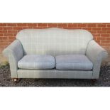 A contemporary two seater sofa in the Laura Ashley style upholstered in grey check fabric, raised on
