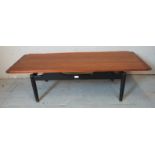 A vintage mid century teak G Plan Librenza 'Long John' coffee table, raised on black painted
