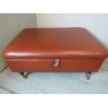 A vintage style ottoman to match previous lot, upholstered in brown leather with brass studs, the