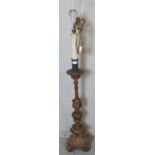 A vintage wooden standard lamp with tapering reed columns ornately carved in the rococo taste,