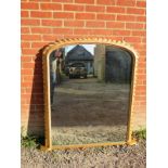 A large 19th century gesso framed over mantle mirror with gadrooned edging and mercury glass