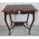 An Edwardian mahogany centre table with shaped top raised on ogee legs with hoof feet, united by a