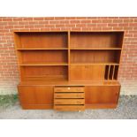 A vintage mid century teak wall unit by Clausen & Son of Denmark, housing an array of shelves & with