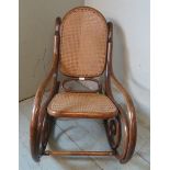 A turn of the century bentwood rocking chair in the manner of Thonet with bergere back & seat