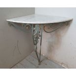 A French Art Deco style marble topped wall mounting corner shelf, raised on a wrought iron