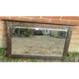 An Art Nouveau bevelled rectangular wall mirror, the planished copper frame featuring cornice &