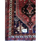 A good Qashqai rug with double central motifs on claret ground and in good condition. 1.65 x 1.10.