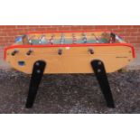 A good quality table football game by Bonzini in solid beech with removeable legs. Includes four