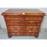 A 19th century continental flame mahogany chest of four long graduated blind drawer, flanked by