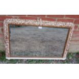 A 19th century over mantle mirror in an ornate gesso frame with original silvered mirror plate,
