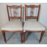 A pair of Edwardian mahogany occasional chairs with carved & pierced backrests, raised on ring