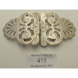 A white metal unmarked nurses buckle with engraved decoration, approx weigh 1 troy oz/33 grams.