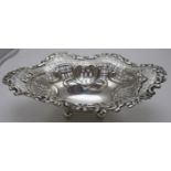 A silver openwork dish on ball feet decorated with bows & swags with foliate design around the edge,