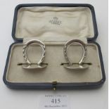 A pair of Asprey's silver horse shoe menu holders, London 1906, in original box. Condition report: