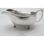 An A E Jones Arts & Crafts silver planished sauce boat, Birmingham 1923, approx weight 5 troy oz/156