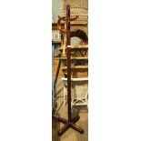 A WOODEN FREESTANDING HAT & COAT STAND on 'X' shaped base