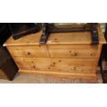 A MODERN PINE LOW THREE DRAWER CHEST on plain plinth base