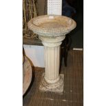 A CAST CONCRETE PEDESTAL BIRD BATH