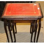 A MODERN NEST OF THREE TABLES with gilt tooled red skiver insert tops