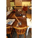 A 20TH CENTURY MAHOGANY DINING TABLE with central leaf supported on twin canon barrel columns