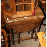 A SMALL SIZED OAK FINISHED TWIN FLAP GATELEG TABLE on barley twist legs