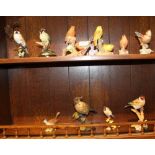 TWO SHELVES CONTAINING A SELECTION OF MODEL BIRDS, to include Royal Worcester examples and Country