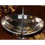 A HALLMARKED SILVER SWING HANDLED PEDESTAL BOAT SHAPED BOWL with engraved armorial crest (249g)