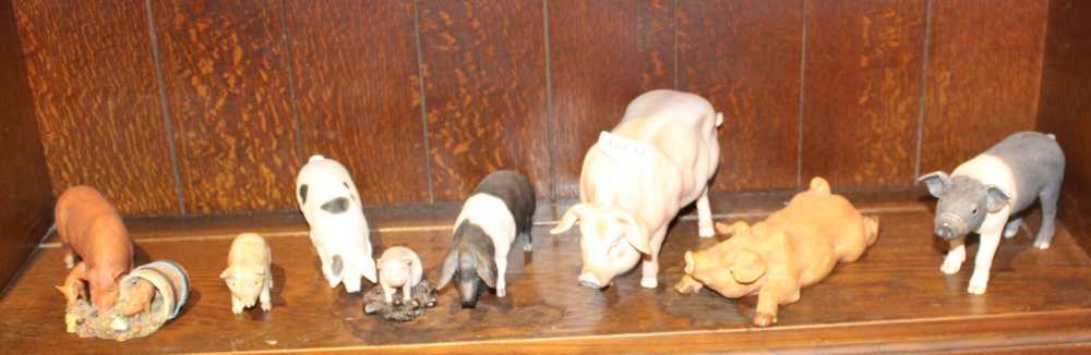 A SHELF FULL OF MODEL PIGS