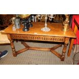 A WELL MADE REPRODUCTION LIGHT OAK RECTANGULAR TOPPED COFFEE TABLE, having carved frieze on baluster