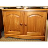 A MODERN PINE LOW TWO DOOR SIDE CABINET