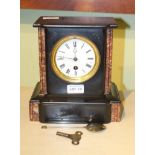 A LATE 19TH CENTURY SLATE MANTEL TIMEPIECE with pendulum and key