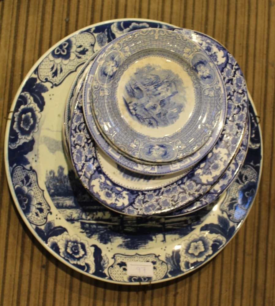 A LARGE BLUE & WHITE DELFT CHARGER together with a selection of blue & white transfer decorated