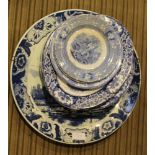 A LARGE BLUE & WHITE DELFT CHARGER together with a selection of blue & white transfer decorated