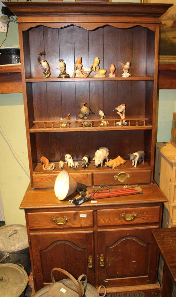 A REPRODUCTION OAK FINISHED DRESSER TYPE UNIT, having plate rack back, with two inline drawers,