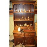 A REPRODUCTION OAK FINISHED DRESSER TYPE UNIT, having plate rack back, with two inline drawers,