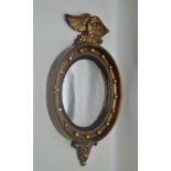 A REGENCY DESIGN GILT FRAMED CONVEX WALL MIRROR with ball frame and eagle crest, plate size; 28cm
