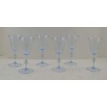 A SET OF SIX MURANO WINE GLASSES, pale blue tinted with bell bowls, knopped stems on raised circular